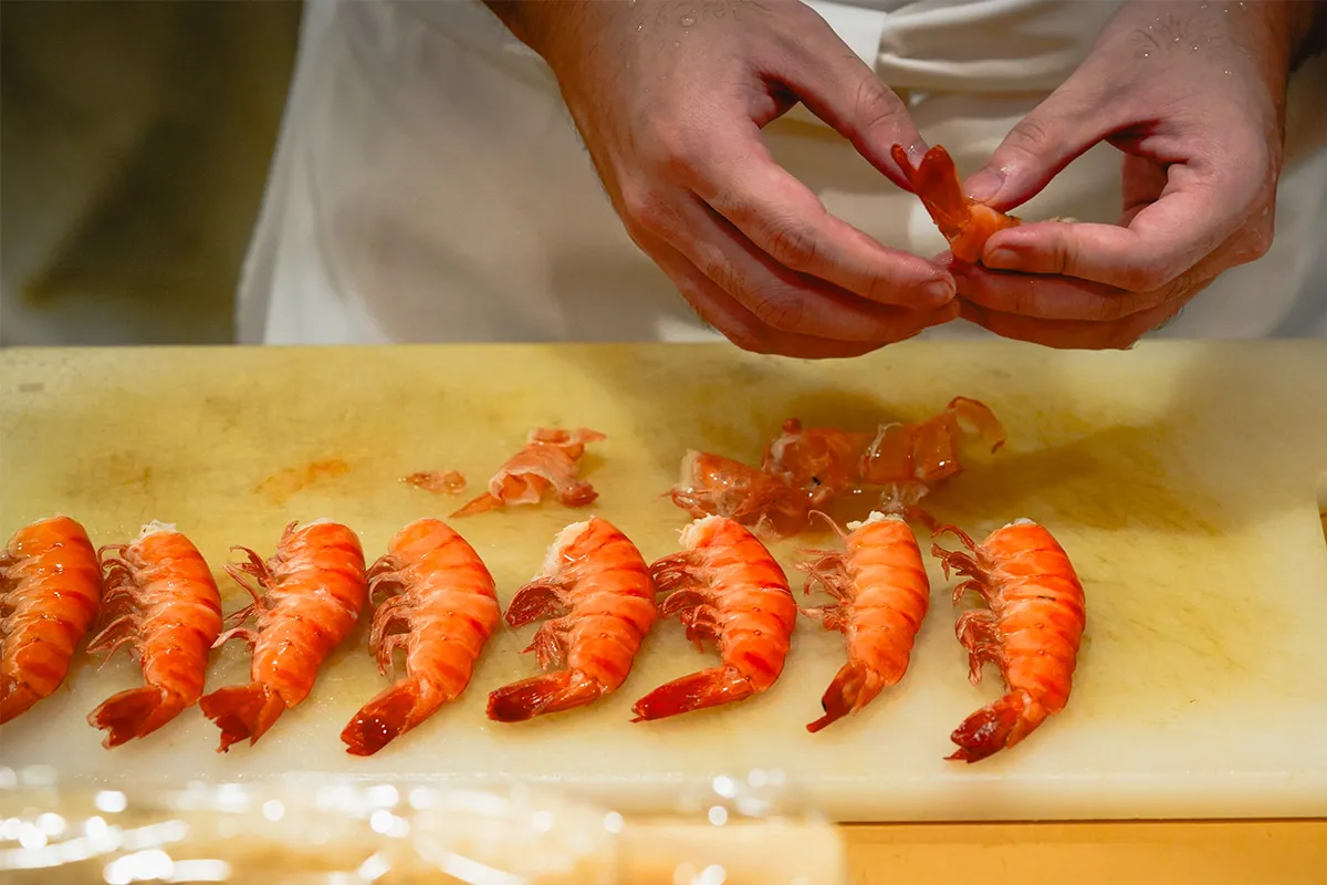Preparing shrimps for sushi